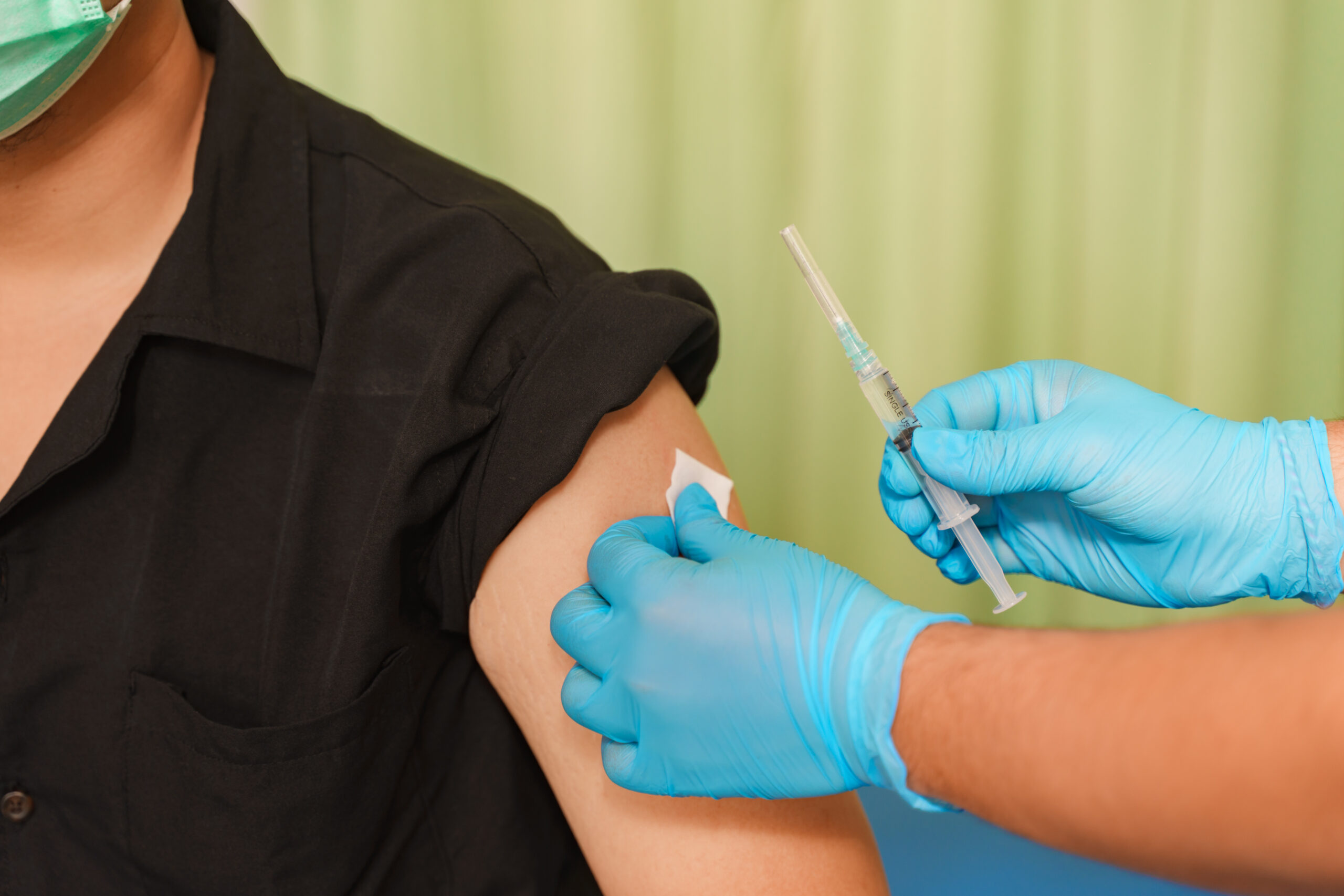 Nurse giving an injection to a patient's arm at Maha Medicare